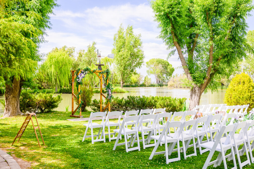 wedding decor and setup at the Windmill House on lawn next to trees and lake in Northern Arizona Chino Valley