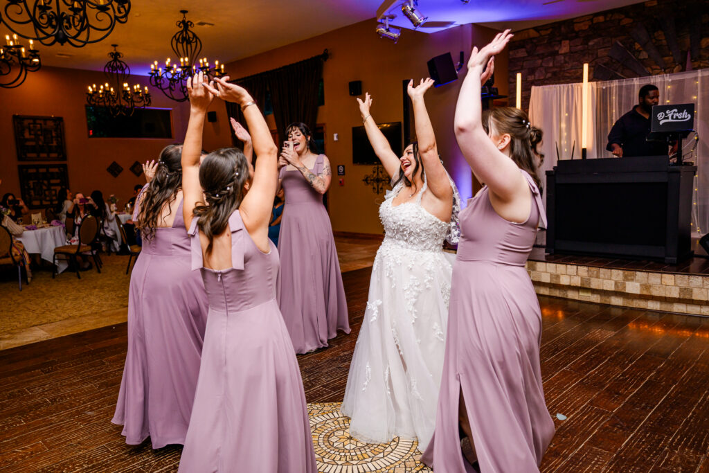 bride dancing with bridesmaids on dance floor during reception at the Windmill House in Chino Valley Prescott Arizona 
